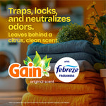 Stack of folded towels with Gain and Febreze logos and text describing odor neutralizing, on a warm blurred home background.