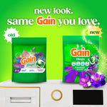 Promotional graphic showing old and new Gain flings packaging side-by-side on a bright green background