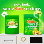 Promotional graphic comparing old and new Gain Flings packaging with bright green background and product pouches