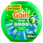 Green plastic tub of Gain Flings laundry pods labeled 'waterfall delight' with 60ct callout and floral graphics
