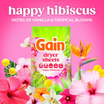 Gain Happy Hibiscus dryer sheets box displayed among tropical flowers with headline notes of vanilla and tropical blooms