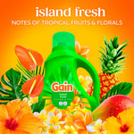 Gain Island Fresh detergent bottle surrounded by tropical fruits and flowers with 'notes of tropical fruits & florals' copy