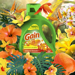Gain Island Fresh detergent bottle surrounded by an array of tropical flowers and foliage in a bright floral composition