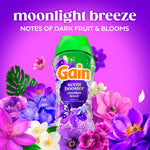Gain scent booster Moonlight Breeze bottle surrounded by vibrant purple and pink flowers and product name text above.