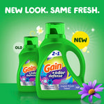 Promotional graphic showing old and new green Gain odor defense detergent bottles with 'new look' text