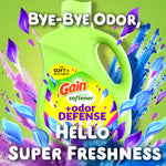 Close-up promotional image of Gain Odor Defense fabric softener bottle with colorful petal graphics and 'Bye-Bye Odor' headline