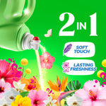 Pouring spout of a green Gain bottle pouring liquid over colorful tropical flowers with 2-in-1 benefits icons