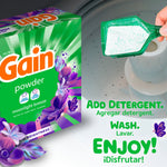 Gain powder box alongside a scoop of powdered detergent being added to a washing machine with instructional text