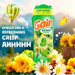 Gain scent booster bottle surrounded by flowers and a hot air balloon graphic with text 'smells like a refreshing crisp ahhh'