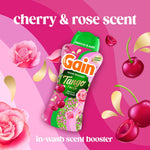 Promotional graphic of Gain Tango Twist bottle surrounded by cherries and roses on a pink background