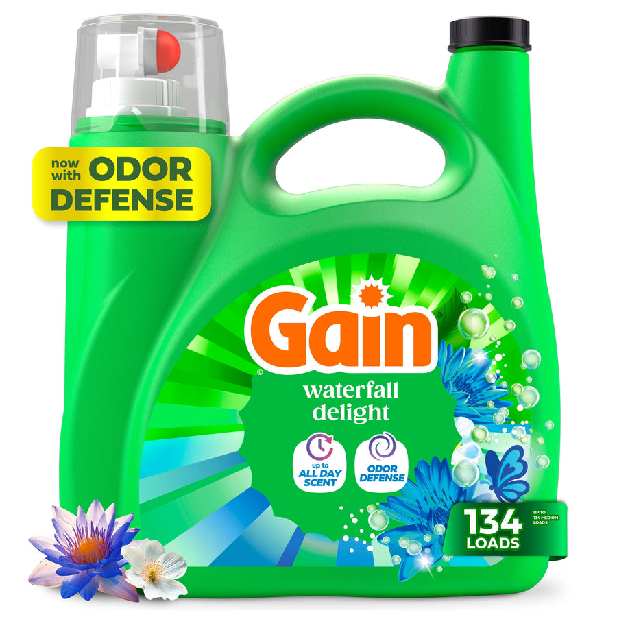 Green Gain laundry detergent jug labeled Waterfall Delight with floral graphics and odor defense badge