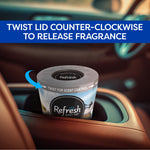 Refresh Your Car gel can shown in a cupholder with instruction banner reading Twist lid counter-clockwise to release fragrance