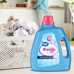 Great Value Gentle Soft fabric softener bottle next to a laundry basket of clothes in a bright laundry room scene.