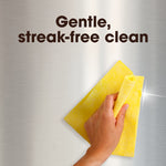 Hand wiping a stainless steel surface with a yellow cloth and headline 'Gentle, streak-free clean'