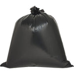 Large tied black garbage bag with glossy surface standing upright on a white background