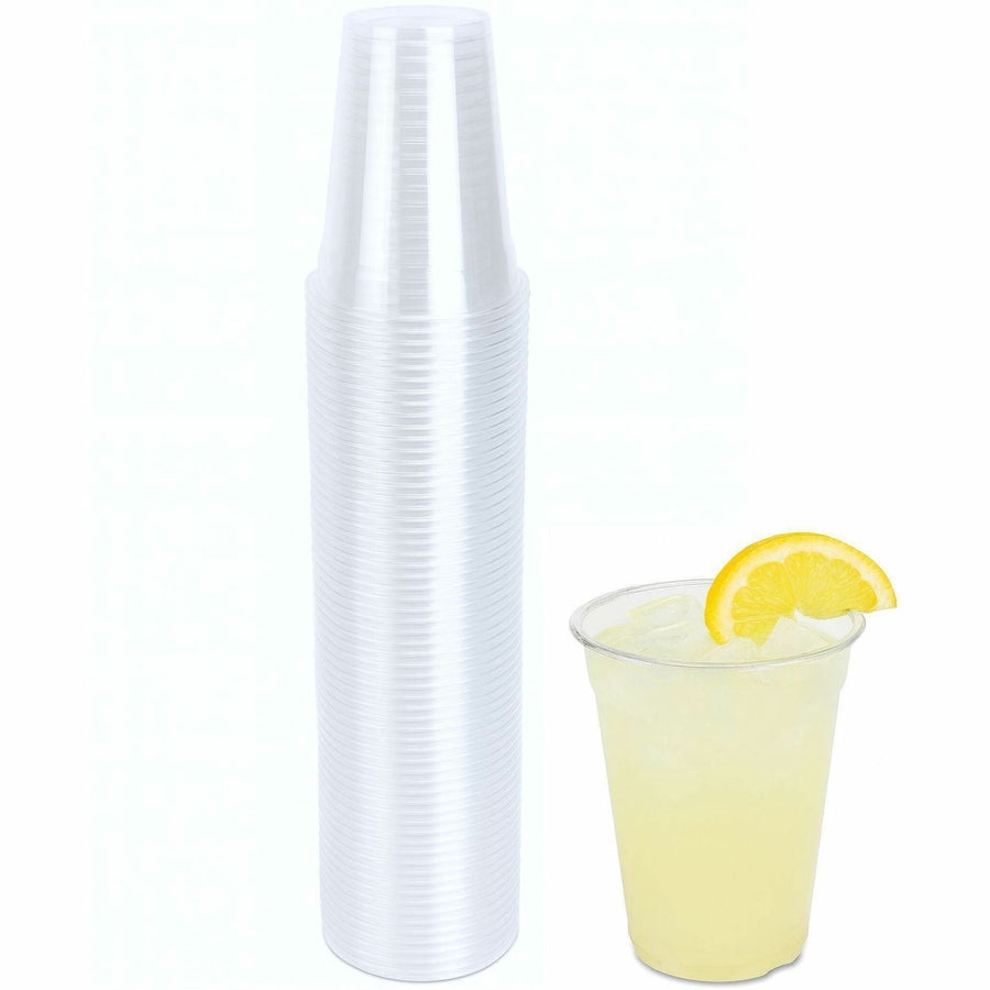 Genuine Joe clear disposable plastic cups stacked tall with a filled cup of lemonade shown beside them.