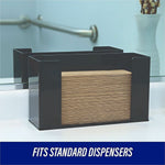 Stack of brown multifold paper towels placed inside a black countertop dispenser in a restroom setting