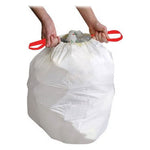 White trash liner closed with a red drawstring being held by two hands, isolated on white background.