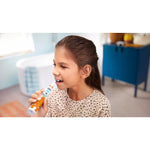 Young girl brushing her teeth with a Philips Sonicare kids toothbrush in a bathroom