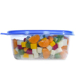 Side view of a clear rectangular Glad container filled with mixed fruit pieces and sealed with a blue lid.