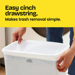 Close-up of hands cinching a white drawstring trash bag inside a rectangular waste bin with 'Easy cinch drawstring' header