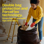 Lifestyle image of a person loading debris into a large Glad heavy duty trash bag with text about double bag protection and ForceFlex