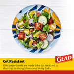 Top view of a Glad paper bowl with scribble abstract print filled with a fresh salad, Glad logo panel