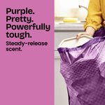 Lifestyle-style image of a purple textured Glad trash bag being held open with text: Purple. Pretty. Powerfully tough.