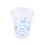 Top-angled view of a Glad clear plastic cup decorated with multiple blue shark illustrations and Glad logo