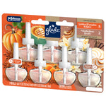 Angled front shot of Glade plug-ins refill blister pack with seven transparent refill bottles and autumn pumpkin and vanilla artwork