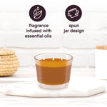 Glade three-wick candle on a white surface with icons and text calling out fragrance infused with essential oils and spun jar design.
