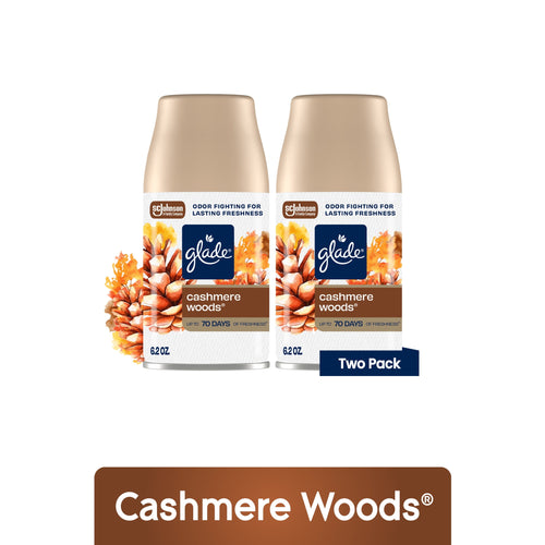 Two Glade Cashmere Woods automatic spray refill cans with floral pinecone artwork and two-pack label