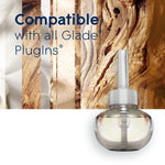 Single Glade refill bottle displayed at bottom right with text “Compatible with all Glade PlugIns” on textured wood background