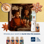 Mother and child baking cookies in warm kitchen scene with Glade dispenser and Cozy Gingerbread refill displayed