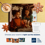Warm lifestyle image of parent and child decorating cookies with Glade Cozy Gingerbread candle graphic and holiday accents