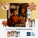 Mother and child baking in warm kitchen with Glade PlugIns product images and seasonal gingerbread decorations