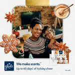 Smiling mother and child in holiday setting with Glade plug-in product images and seasonal gingerbread decorations.