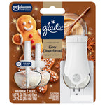 Front view of Glade Cozy Gingerbread PlugIns starter kit packaging showing warmer, two refills and festive gingerbread art