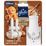 Glade Cozy Gingerbread PlugIns starter kit blister pack showing warmer and two refill bottles with gingerbread background