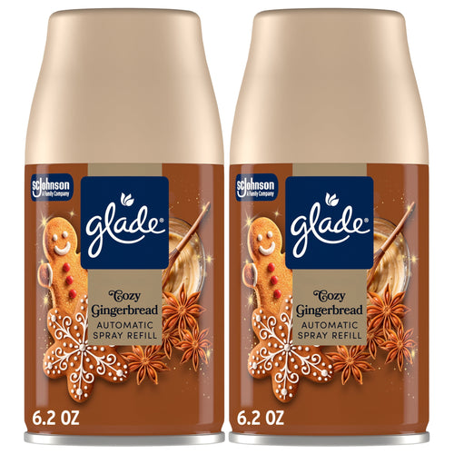 Two Glade Cozy Gingerbread automatic spray refill cans with gingerbread cookie graphics