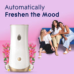Glade automatic dispenser with three people on a couch in background and text ‘Automatically Freshen the Mood’