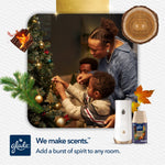 Family decorating a Christmas tree with a Glade automatic spray unit and Fall Night Long refill shown at the bottom right.