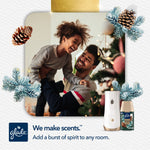 Smiling father and child near decorated tree with Glade automatic dispenser and Twinkling Pine & Cedar refill pictured
