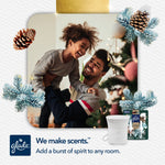 Playful lifestyle image of a smiling father lifting a child, with Glade device and refill pictured at the corner and holiday accents.