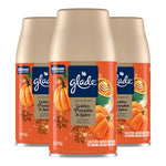 Three Glade Golden Pumpkin & Spice automatic spray refill cans with orange seasonal label
