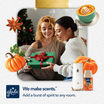 Two people exchanging a gift with Glade automatic dispenser and Golden Pumpkin & Spice refill shown at corner
