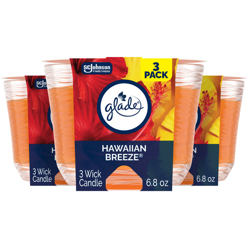 Three Glade Hawaiian Breeze 3-wick candles in orange wax with branded cardboard sleeve and tropical floral art