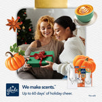 Holiday lifestyle image of two people exchanging a gift, decorated with pumpkin and spice graphics and Glade logo