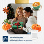 Holiday lifestyle image of two people exchanging a gift, decorated with pumpkin and candle graphics and a Glade candle illustration
