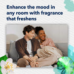 Lifestyle image of a smiling couple on a couch with headline about enhancing the mood in any room with fragrance